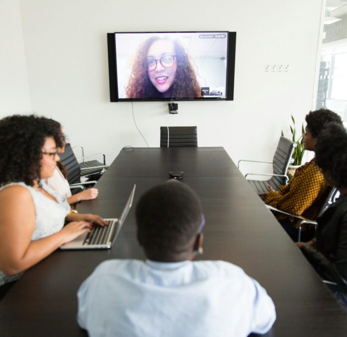 Conference room with participant on a screen