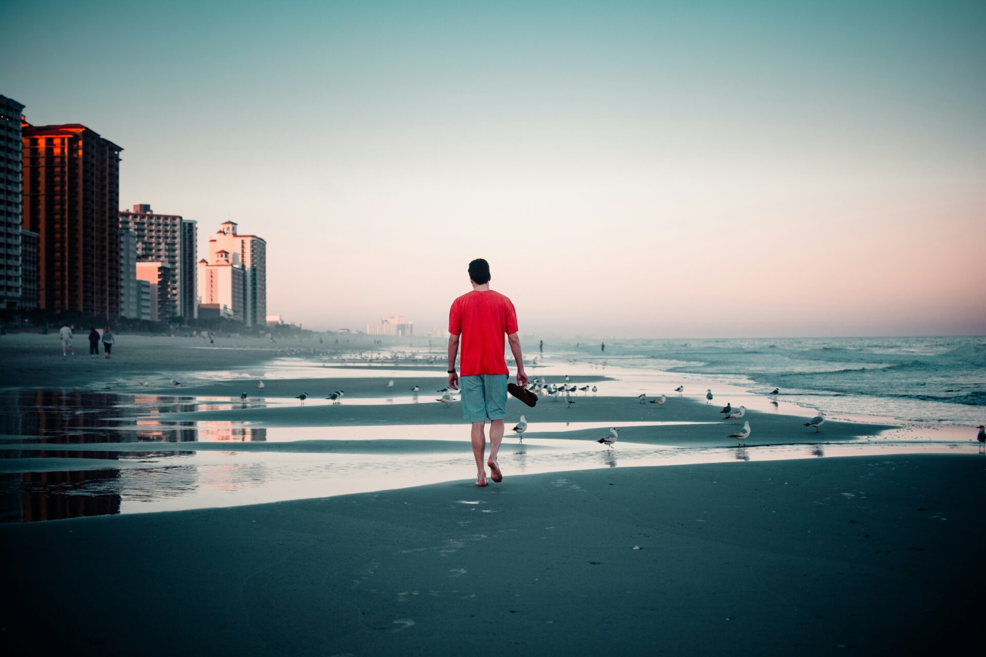Man walking on the beach without shoes